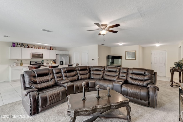 tiled living room featuring a textured ceiling and ceiling fan