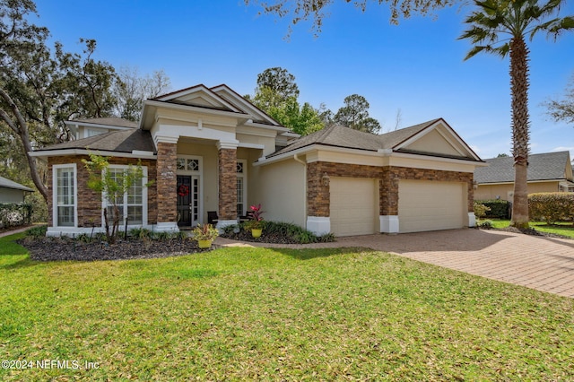 view of front of home featuring a front lawn and a garage