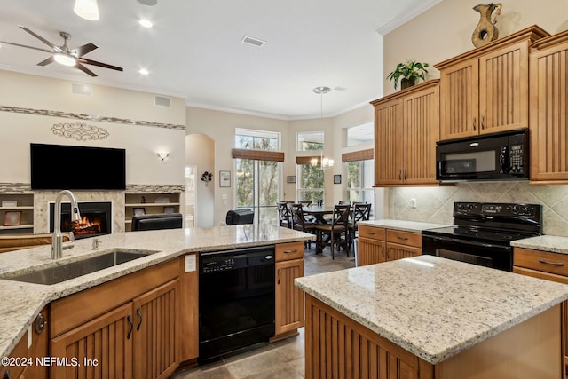 kitchen with light stone countertops, backsplash, ceiling fan with notable chandelier, black appliances, and light tile flooring