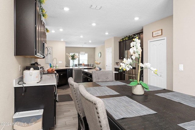 dining space featuring sink and light wood-type flooring