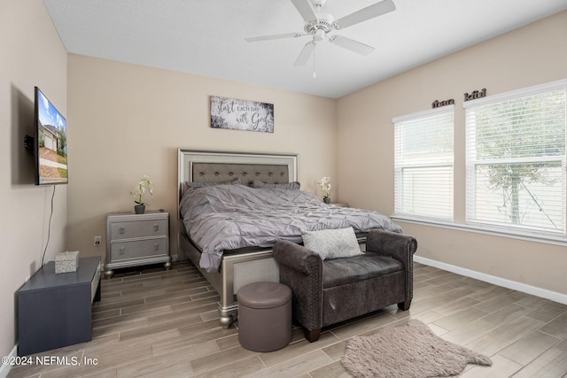 bedroom with ceiling fan and light hardwood / wood-style flooring