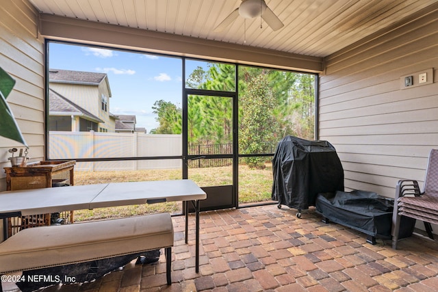 sunroom / solarium featuring ceiling fan