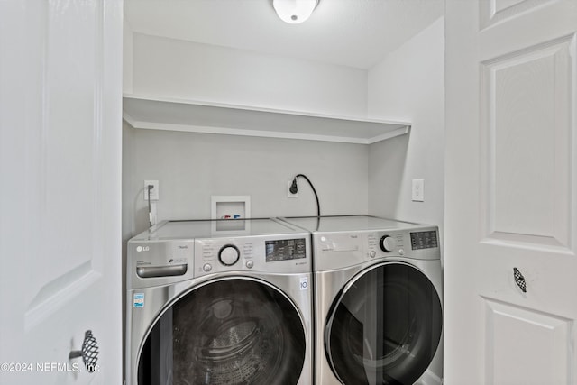 laundry room featuring hookup for an electric dryer, hookup for a washing machine, and washer and dryer