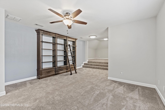 carpeted spare room featuring ceiling fan