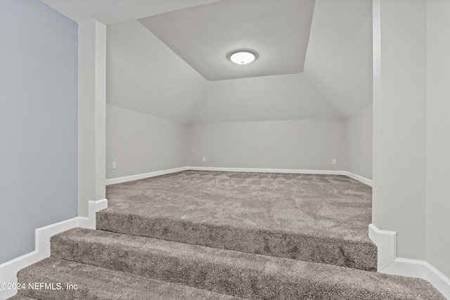 bonus room with lofted ceiling and carpet floors