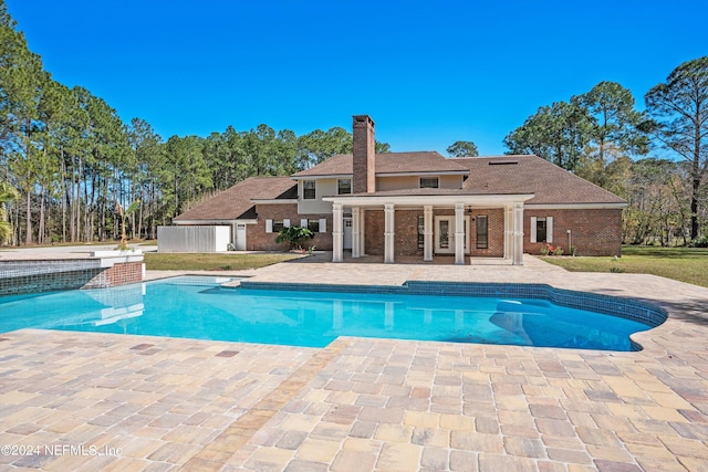 view of swimming pool featuring a patio and a lawn