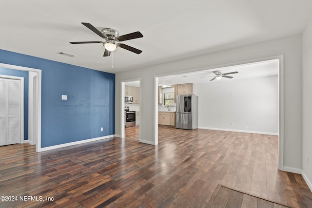 unfurnished living room with dark hardwood / wood-style flooring, ceiling fan, and sink