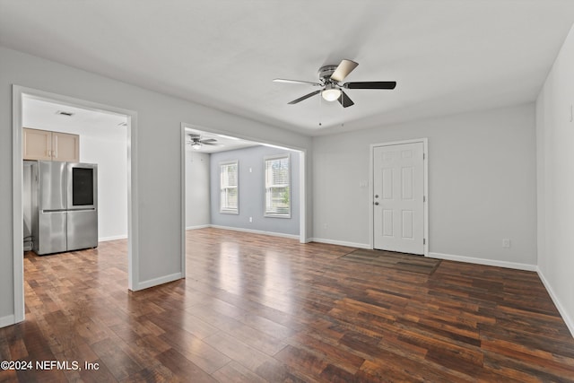 empty room with ceiling fan and dark hardwood / wood-style floors