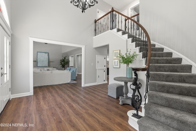 foyer featuring dark hardwood / wood-style flooring and a towering ceiling