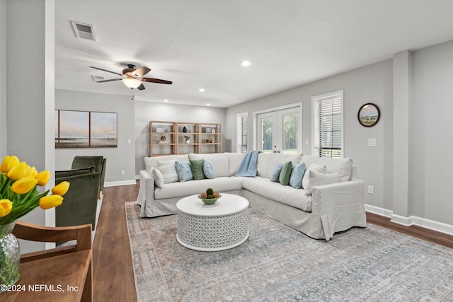 living room featuring french doors, ceiling fan, and dark hardwood / wood-style floors