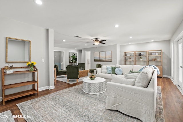 living room with ceiling fan and dark hardwood / wood-style floors