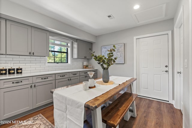 kitchen featuring tasteful backsplash, gray cabinets, and dark hardwood / wood-style floors