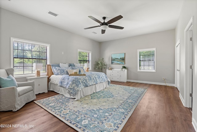 bedroom featuring multiple windows, ceiling fan, and light wood-type flooring