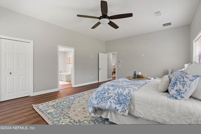 bedroom featuring a closet, dark hardwood / wood-style floors, ceiling fan, and connected bathroom