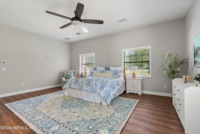 bedroom with dark hardwood / wood-style floors and ceiling fan