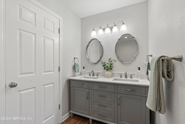 bathroom featuring double sink, wood-type flooring, and oversized vanity