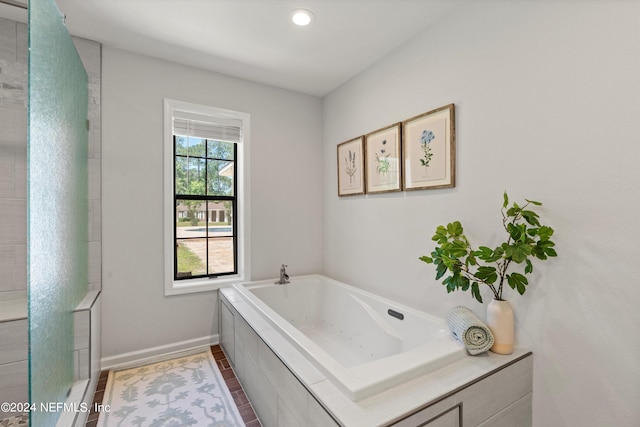 bathroom with tiled tub