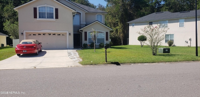 front of property featuring a front yard and a garage