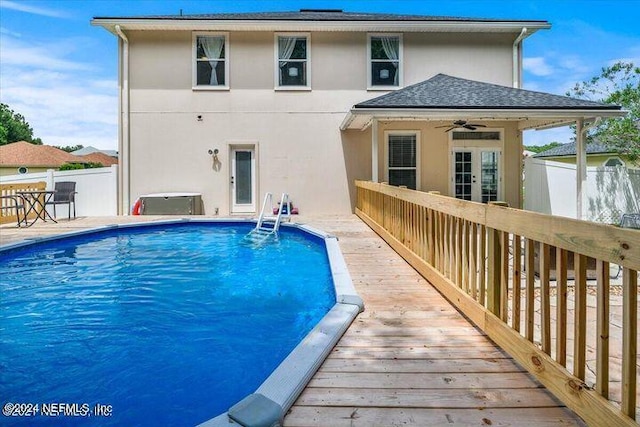 view of swimming pool with ceiling fan and a wooden deck