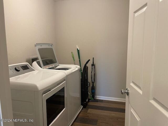 laundry area with dark hardwood / wood-style floors and independent washer and dryer