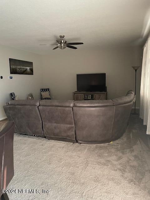 living room featuring ceiling fan and carpet floors