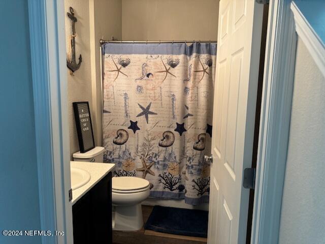 bathroom featuring toilet and vanity