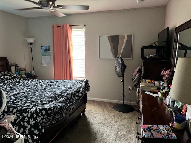 bedroom with ceiling fan and carpet floors