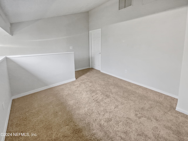 unfurnished room featuring light colored carpet