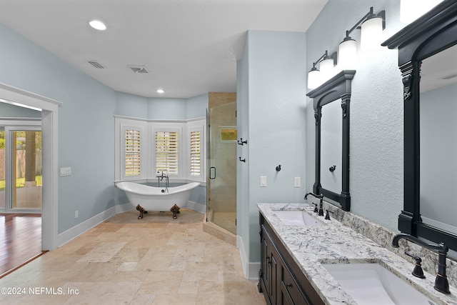 bathroom with tile floors, dual vanity, and plus walk in shower