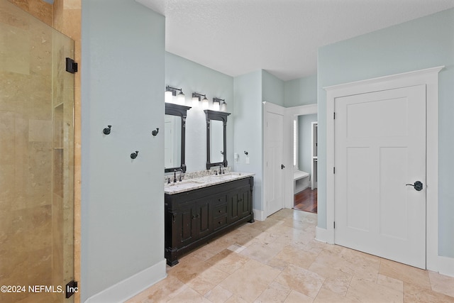 bathroom featuring a tile shower, tile flooring, oversized vanity, and double sink