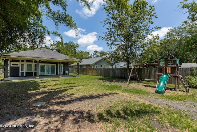 view of yard with a patio area and a playground