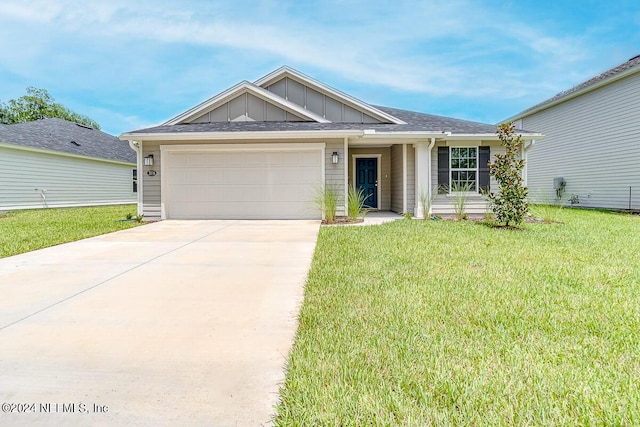 view of front of home featuring a garage and a front lawn