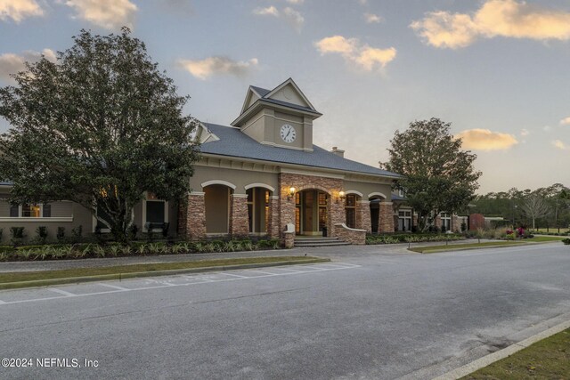 view of front of house featuring uncovered parking and stone siding