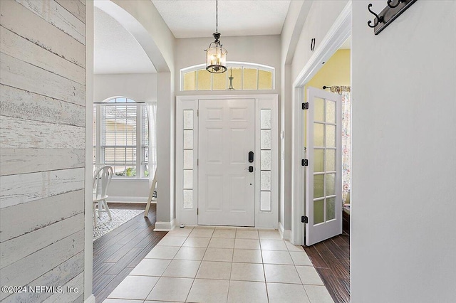 tiled foyer entrance featuring a textured ceiling