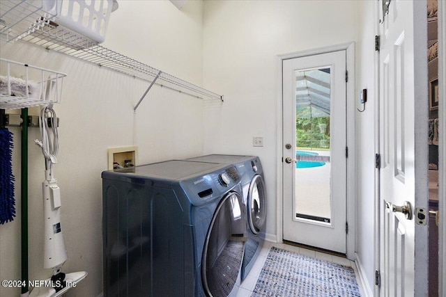 laundry room with light tile patterned floors, laundry area, and washing machine and clothes dryer