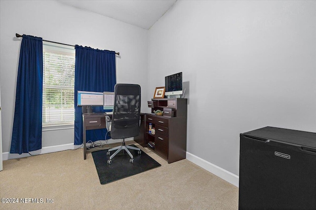 home office featuring carpet, vaulted ceiling, and baseboards