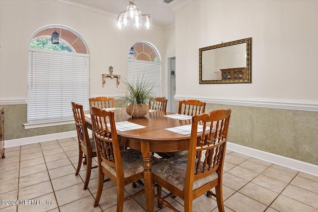 dining space featuring light tile patterned floors, a chandelier, visible vents, baseboards, and crown molding