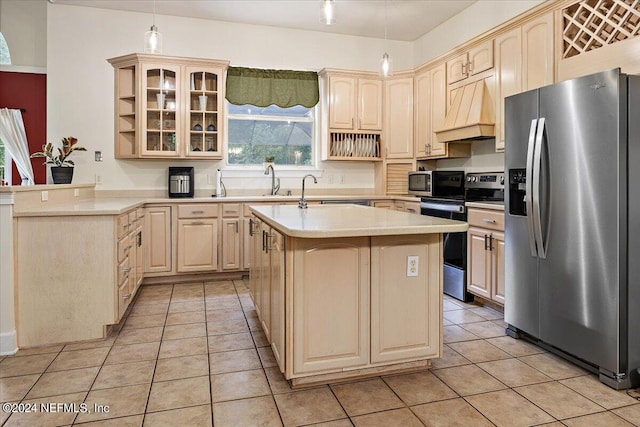 kitchen with light countertops, custom range hood, light brown cabinetry, appliances with stainless steel finishes, and light tile patterned flooring