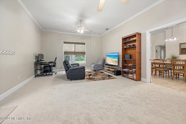 living area featuring carpet floors, crown molding, baseboards, and a ceiling fan