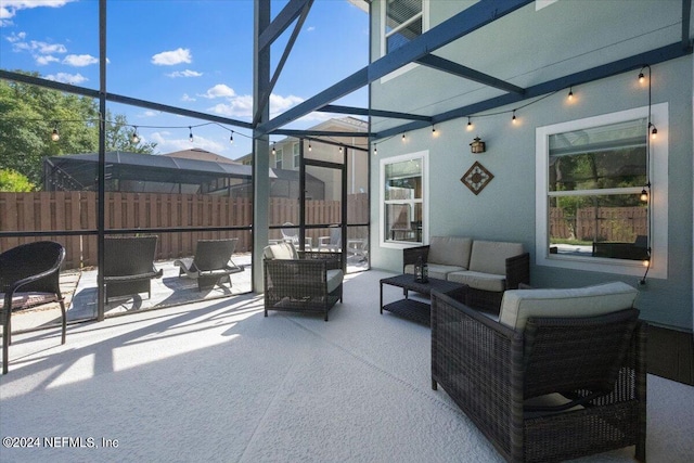 view of patio with an outdoor living space and a lanai