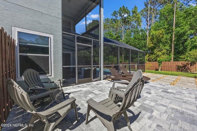 view of patio / terrace featuring a lanai