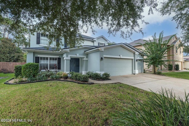 traditional-style home featuring an attached garage, concrete driveway, and a front yard