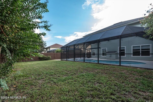 view of yard featuring a lanai and a fenced in pool