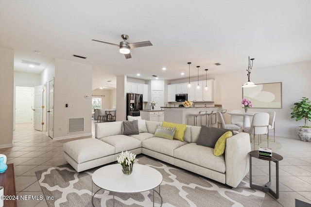 tiled living room with ceiling fan