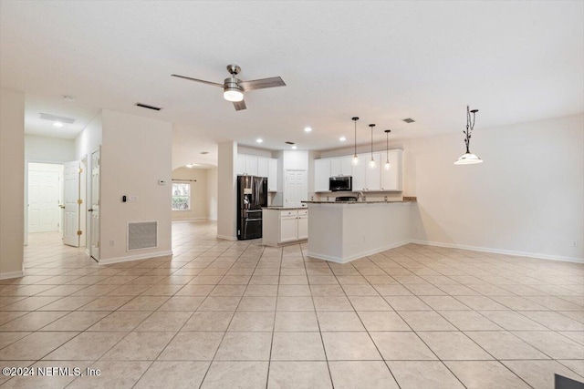 kitchen with white cabinets, hanging light fixtures, ceiling fan, light tile patterned flooring, and stainless steel appliances