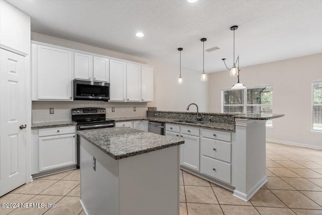 kitchen featuring a center island, white cabinetry, and appliances with stainless steel finishes