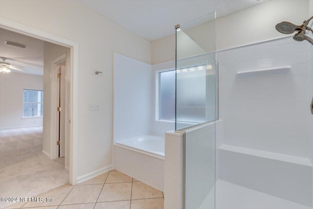 bathroom with plus walk in shower, tile patterned floors, and ceiling fan