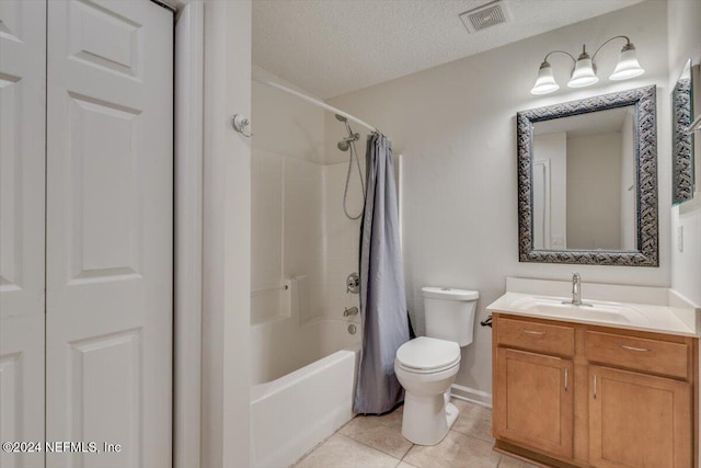 full bathroom with vanity, a textured ceiling, shower / bath combo with shower curtain, tile patterned flooring, and toilet