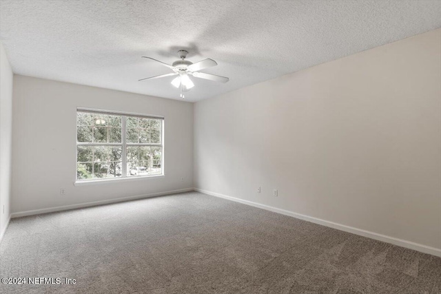 carpeted spare room with ceiling fan and a textured ceiling