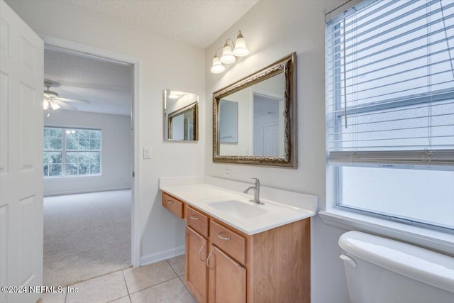 bathroom with vanity, tile patterned floors, ceiling fan, toilet, and a textured ceiling